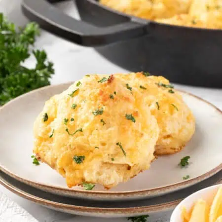 two cheddar bay biscuits on a plate