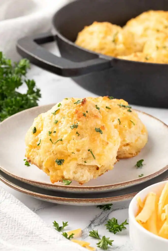 two cheddar bay biscuits on a plate