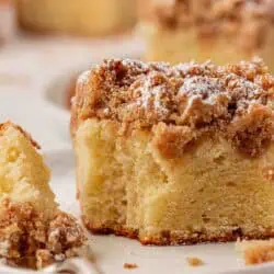 slice of crumb cake on a plate with a fork