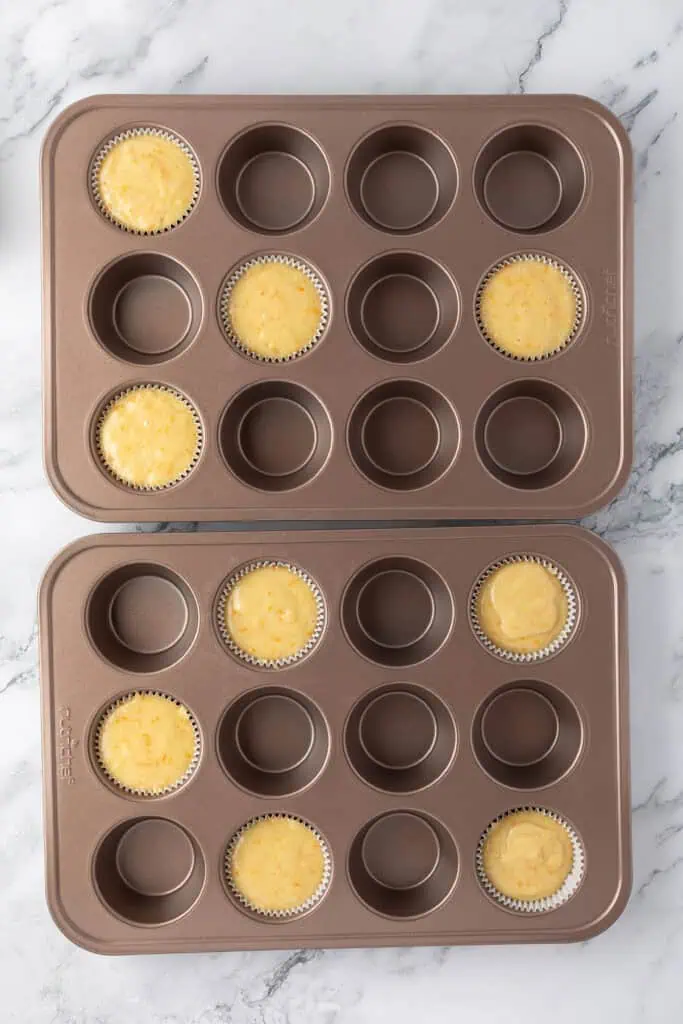 muffin batter added to two pans, spaced out every other well