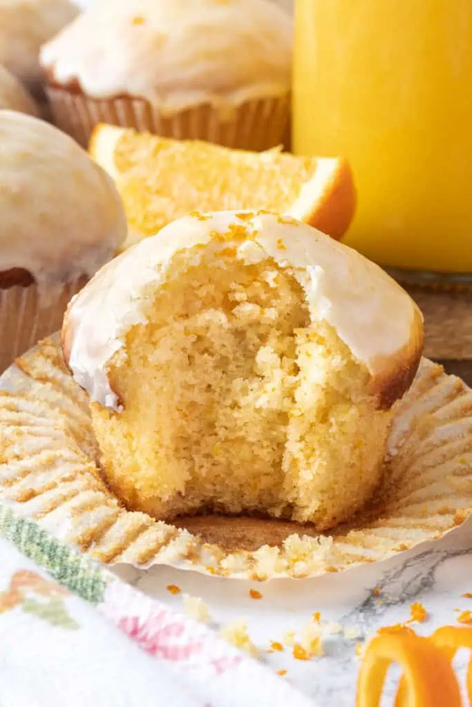 glazed orange muffin with a bite taken out of it