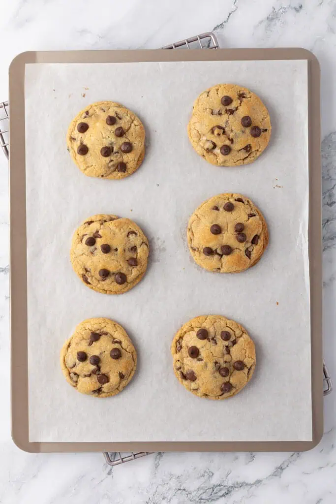 six baked cookies on a cookie sheet