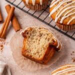 cinnamon roll muffin with a big bite missing