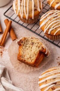 cinnamon roll muffin with a big bite missing
