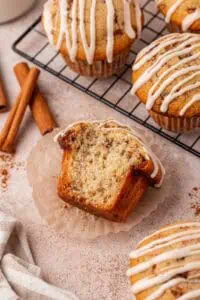cinnamon roll muffin with a big bite missing