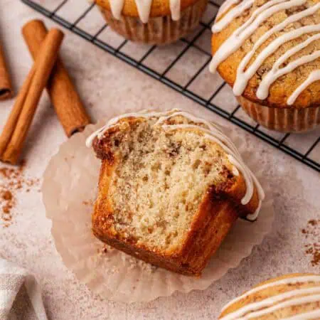 cinnamon roll muffin with a big bite missing