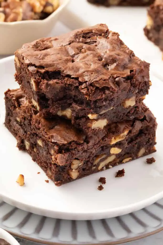 two walnut brownies stacked on top of each other