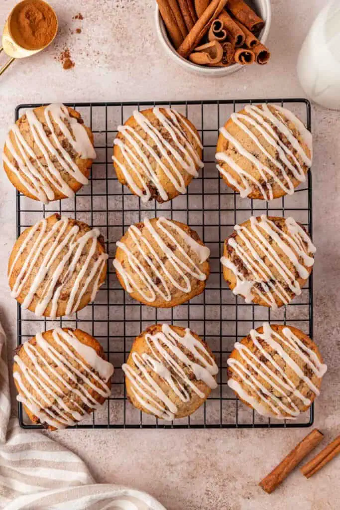 glazed cinnamon roll muffins on a wire rack