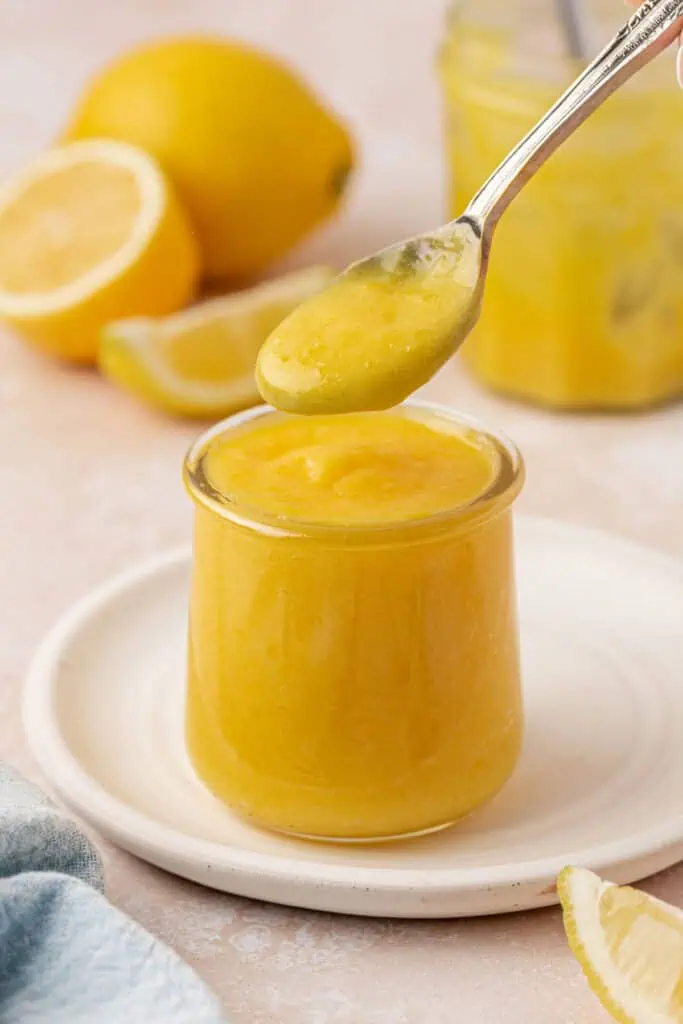 spoon dipping into lemon curd