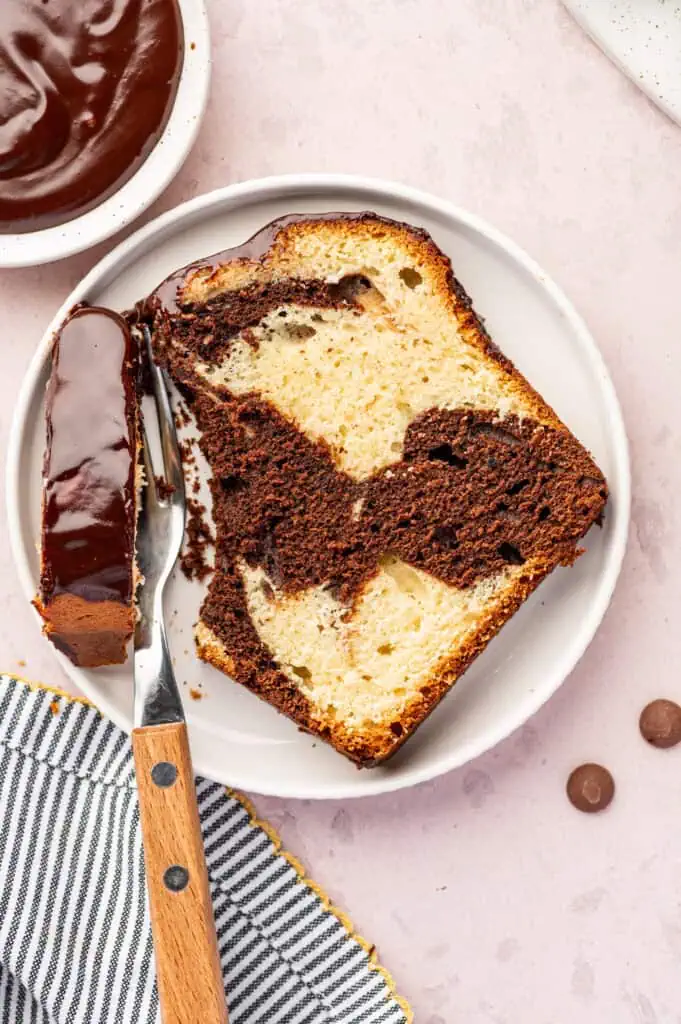 slice of marble loaf cake on a plate with a fork