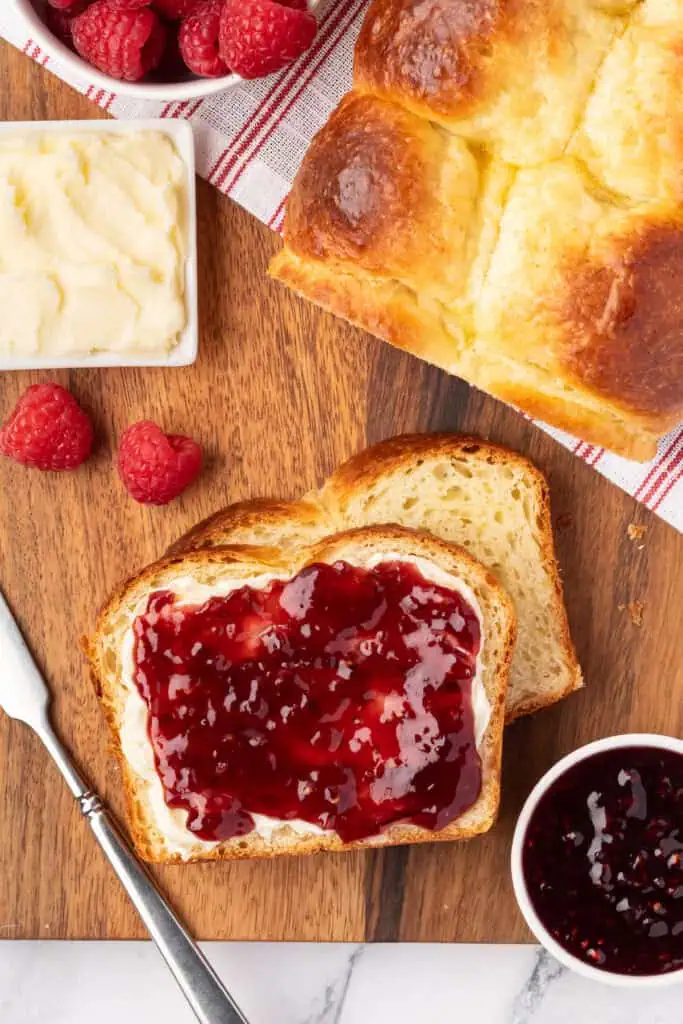 brioche sliced and topped with butter and jam