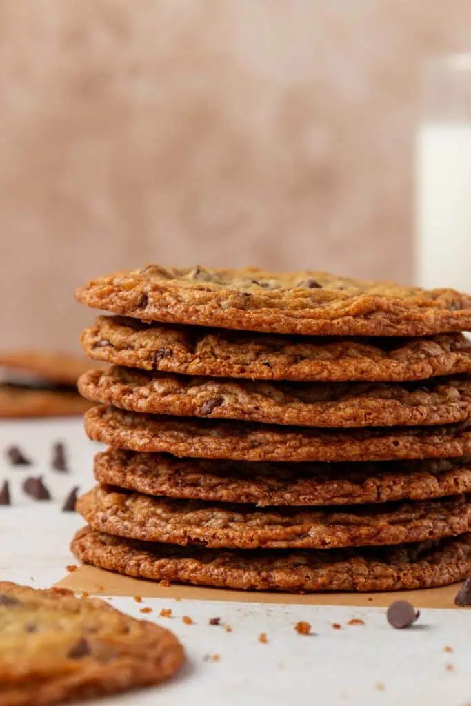 a stack of thin crispy chocolate chip cookies
