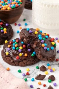 two cosmic brownie cookies slightly stacked on each other with one having a bite taken out of it