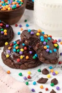 two cosmic brownie cookies slightly stacked on each other with one having a bite taken out of it