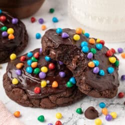 two cosmic brownie cookies slightly stacked on each other with one having a bite taken out of it