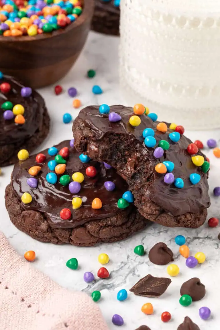 two cosmic brownie cookies slightly stacked on each other with one having a bite taken out of it