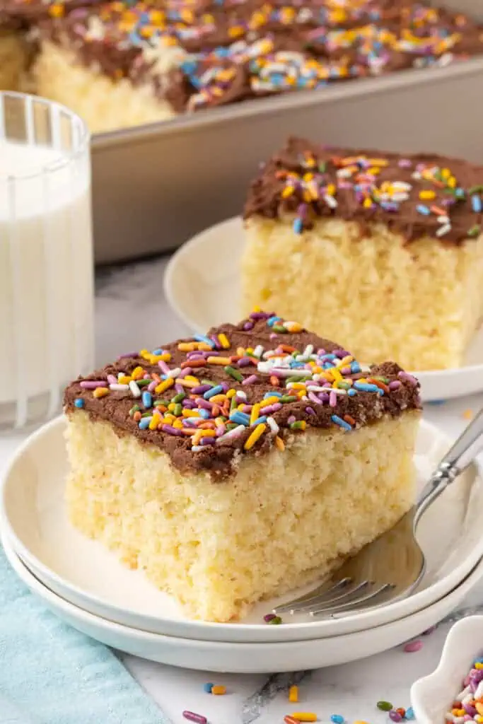 slice of yellow cake on a plate with a fork