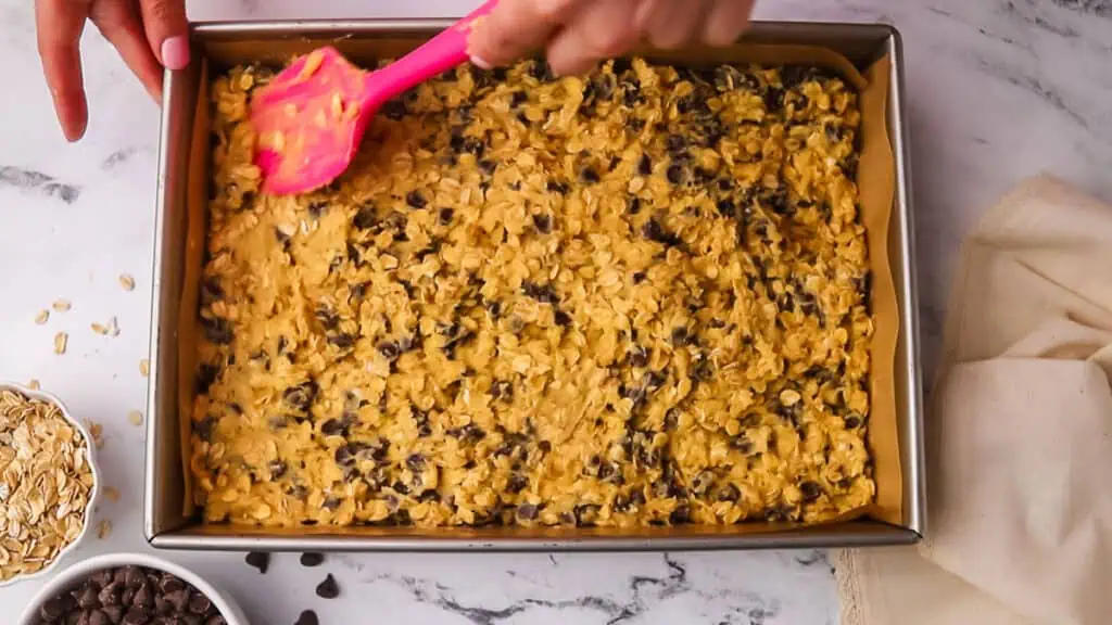 oatmeal cookie dough pressed into the pan