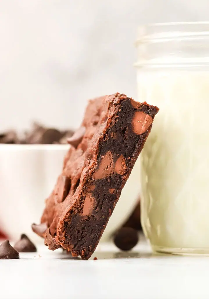 cookie bar leaning against a glass of milk