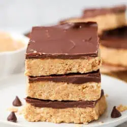 three no bake peanut butter bars on a plate