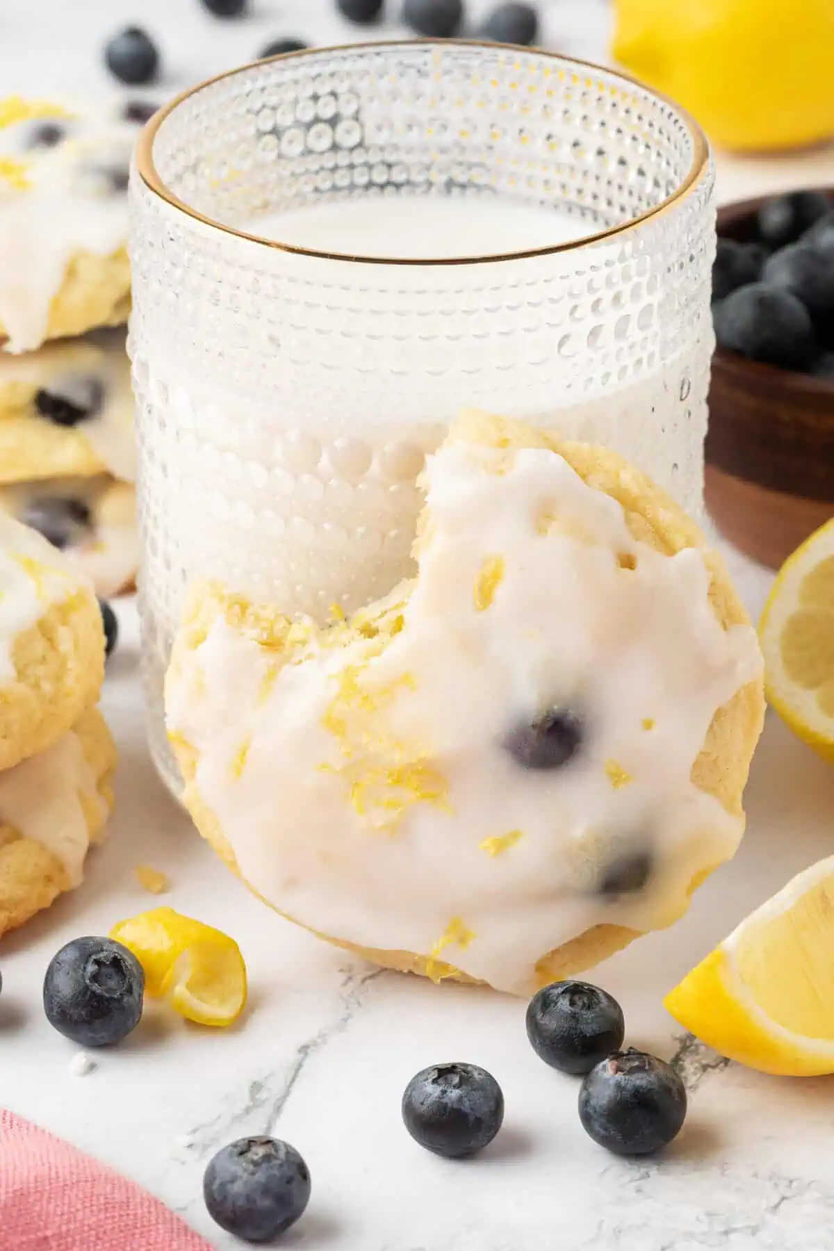 a cookie leaning against a stack of milk