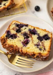 slice of blueberry cinnamon bread on a plate with a fork