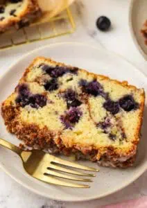 slice of blueberry cinnamon bread on a plate with a fork