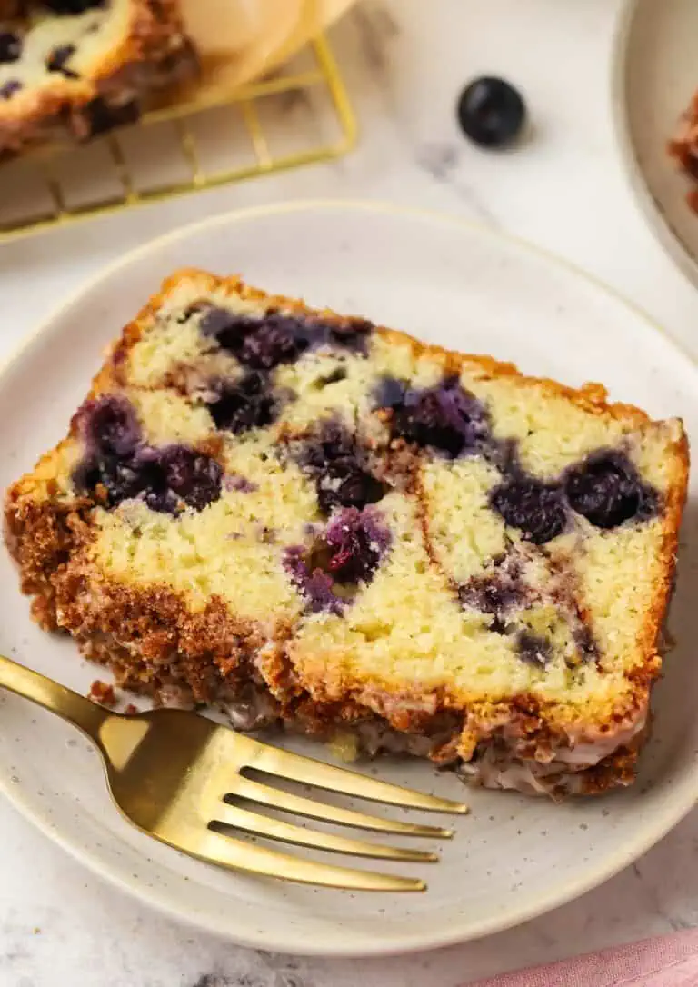 slice of blueberry cinnamon bread on a plate with a fork