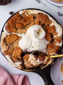 mini fluffernutter cookie skillet topped with ice cream and a spoon in it