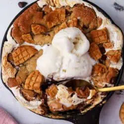 mini fluffernutter cookie skillet topped with ice cream and a spoon in it