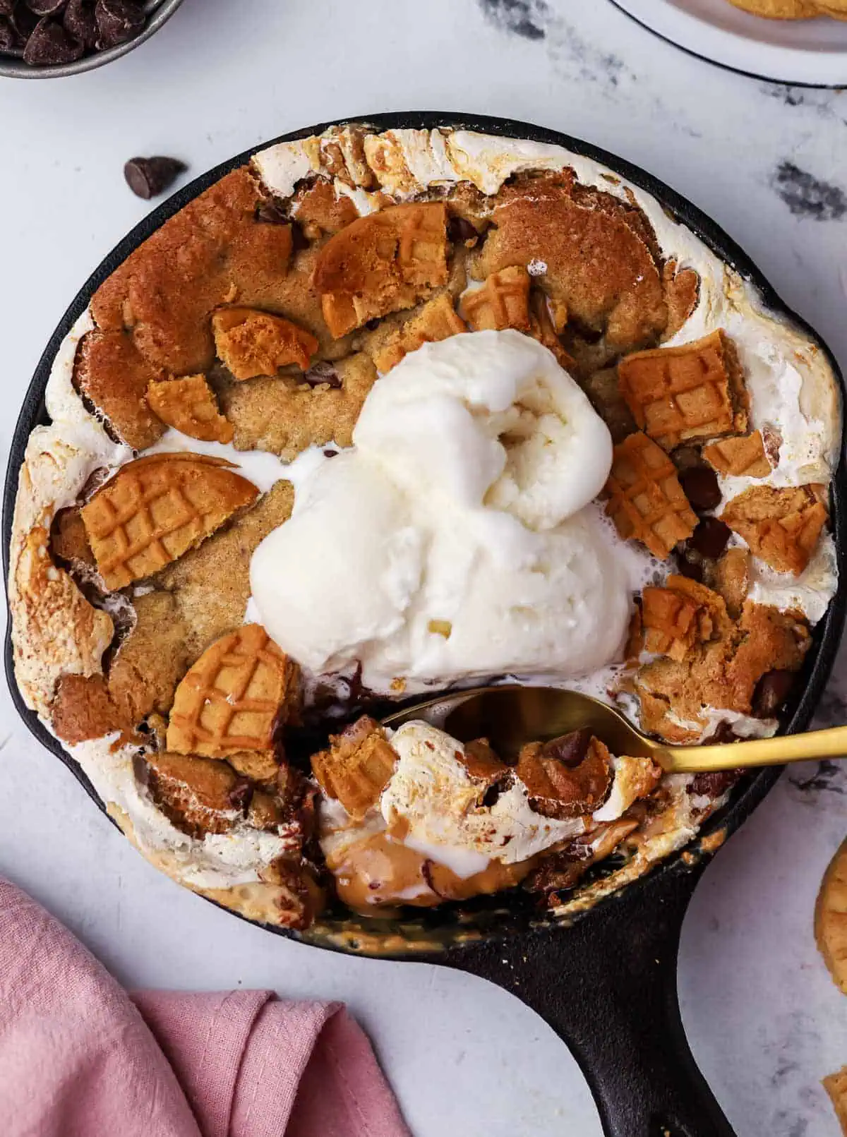 mini fluffernutter cookie skillet topped with ice cream and a spoon in it