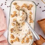 loaf pan of cookie dough ice cream with a cookie scoop in it