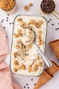 loaf pan of cookie dough ice cream with a cookie scoop in it
