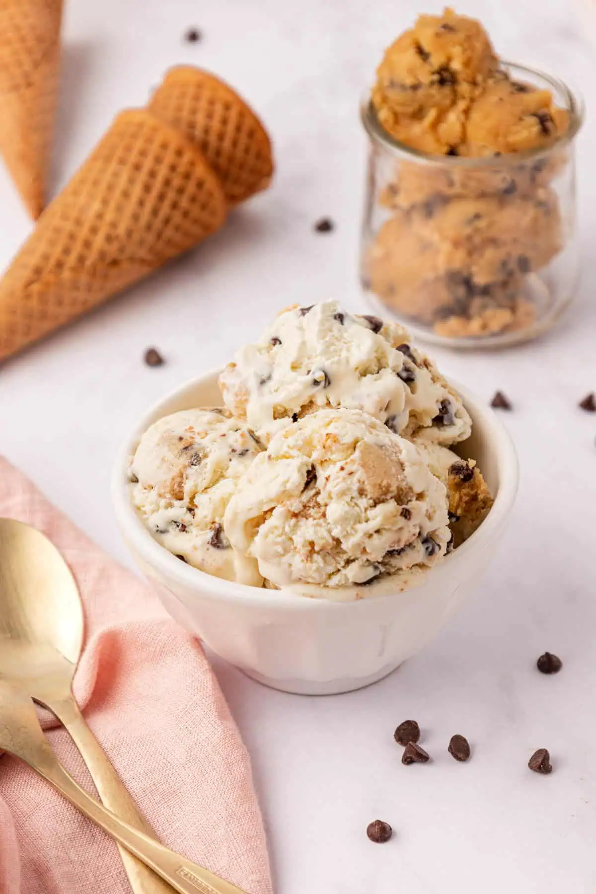 a bowl of cookie dough ice cream with two spoons
