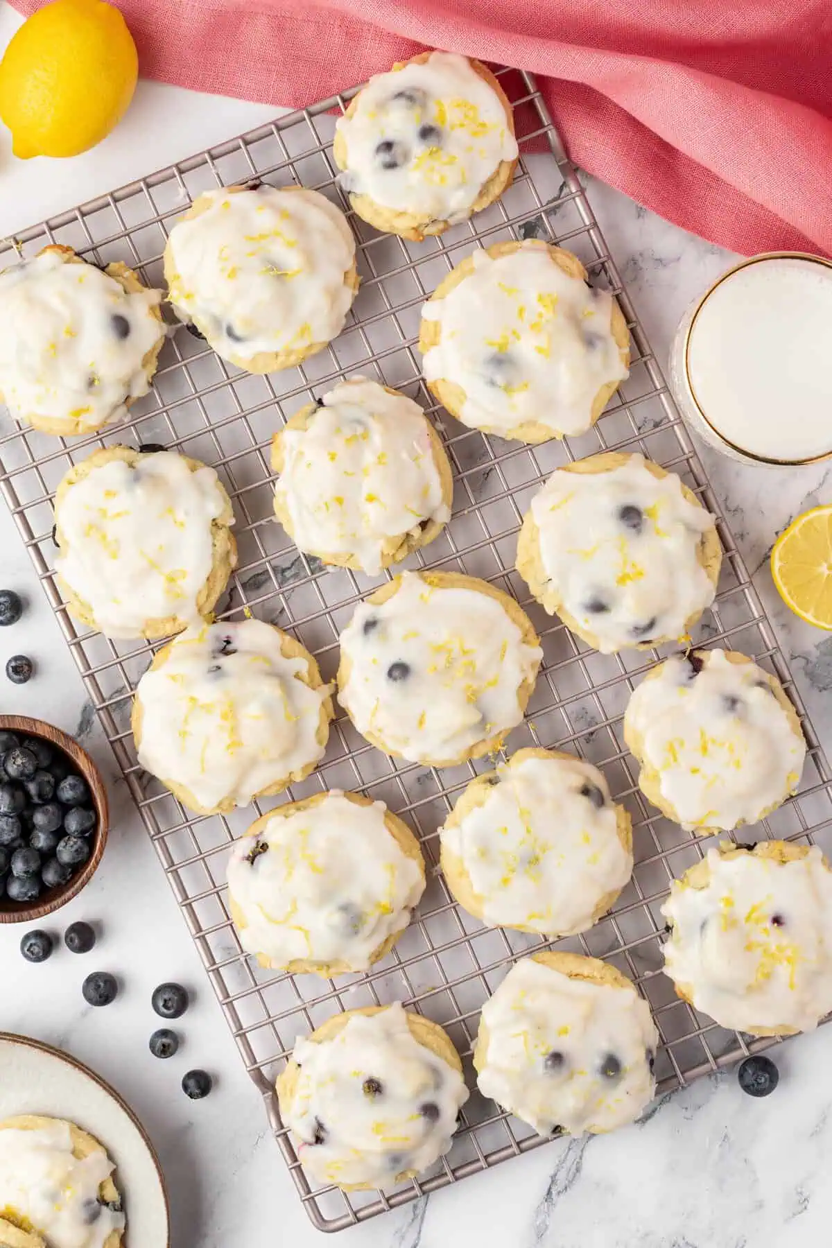 lemon blueberry cookies with icing on a wire rack