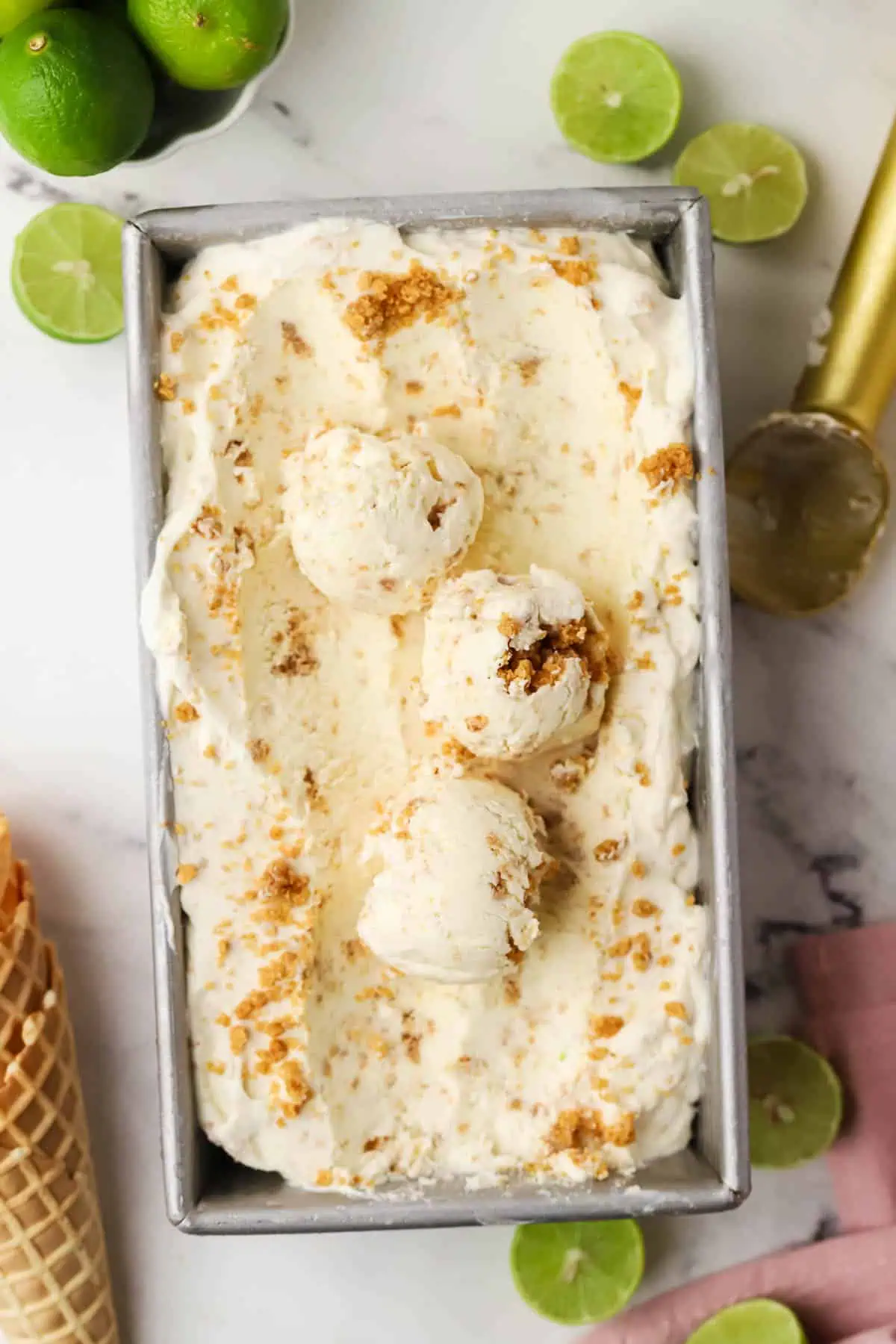 loaf pan of ice cream with three scoops scooped in it