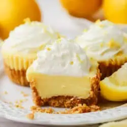 a mini lemon pie cut in half on a plate