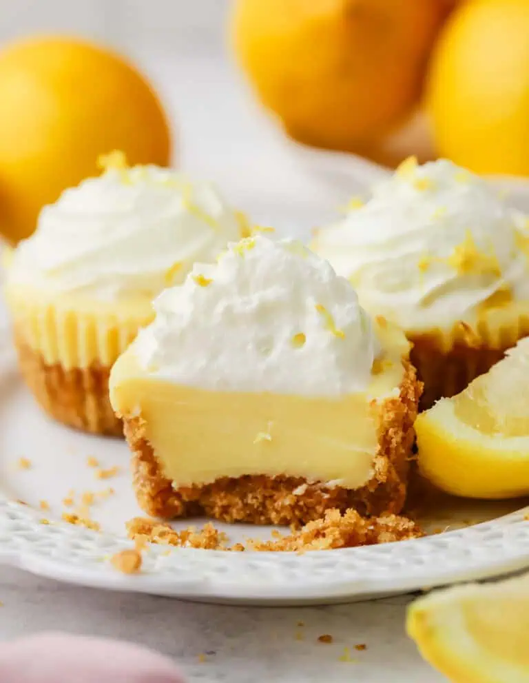 a mini lemon pie cut in half on a plate