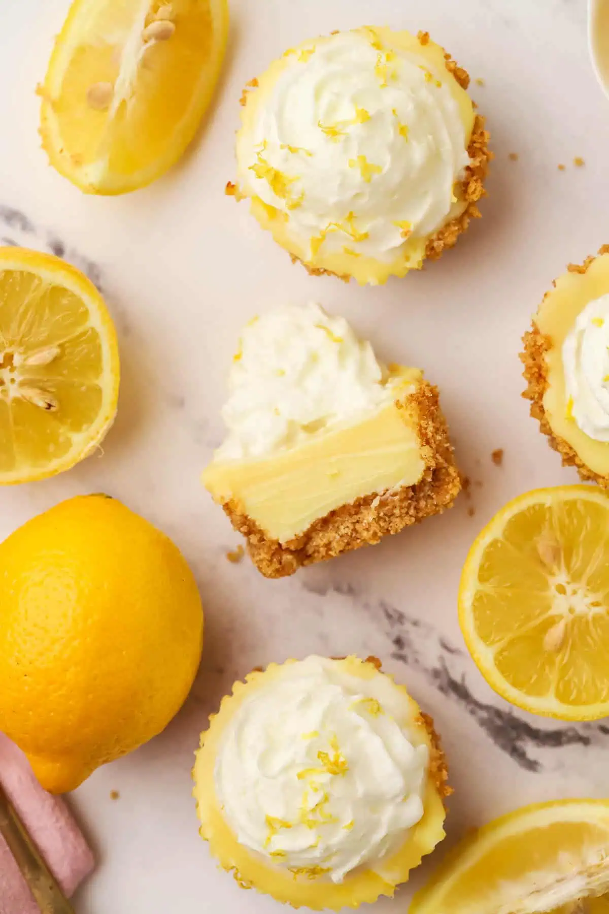 mini lemon pies next to some lemons