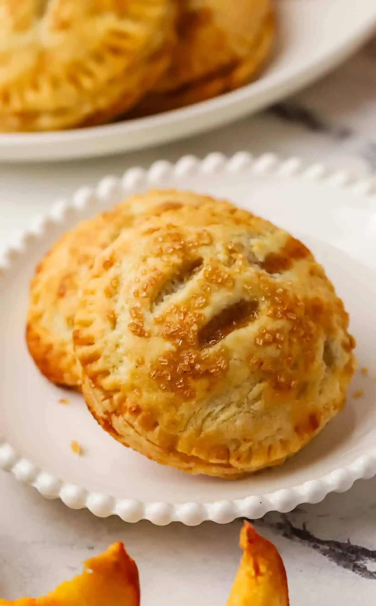 two peach hand pies on a plate