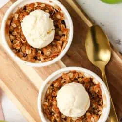 two ramekins of apple crisp topped with apple crisp