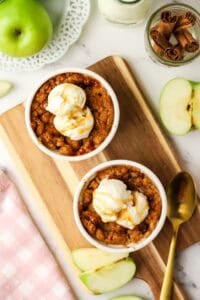 two apple crumbles in ramekins