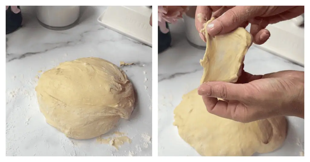 hand holding up dough showing the windowpane test