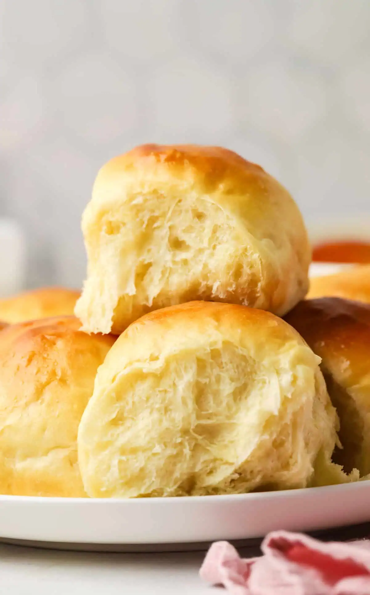 two Hawaiian Rolls stacked on a plate