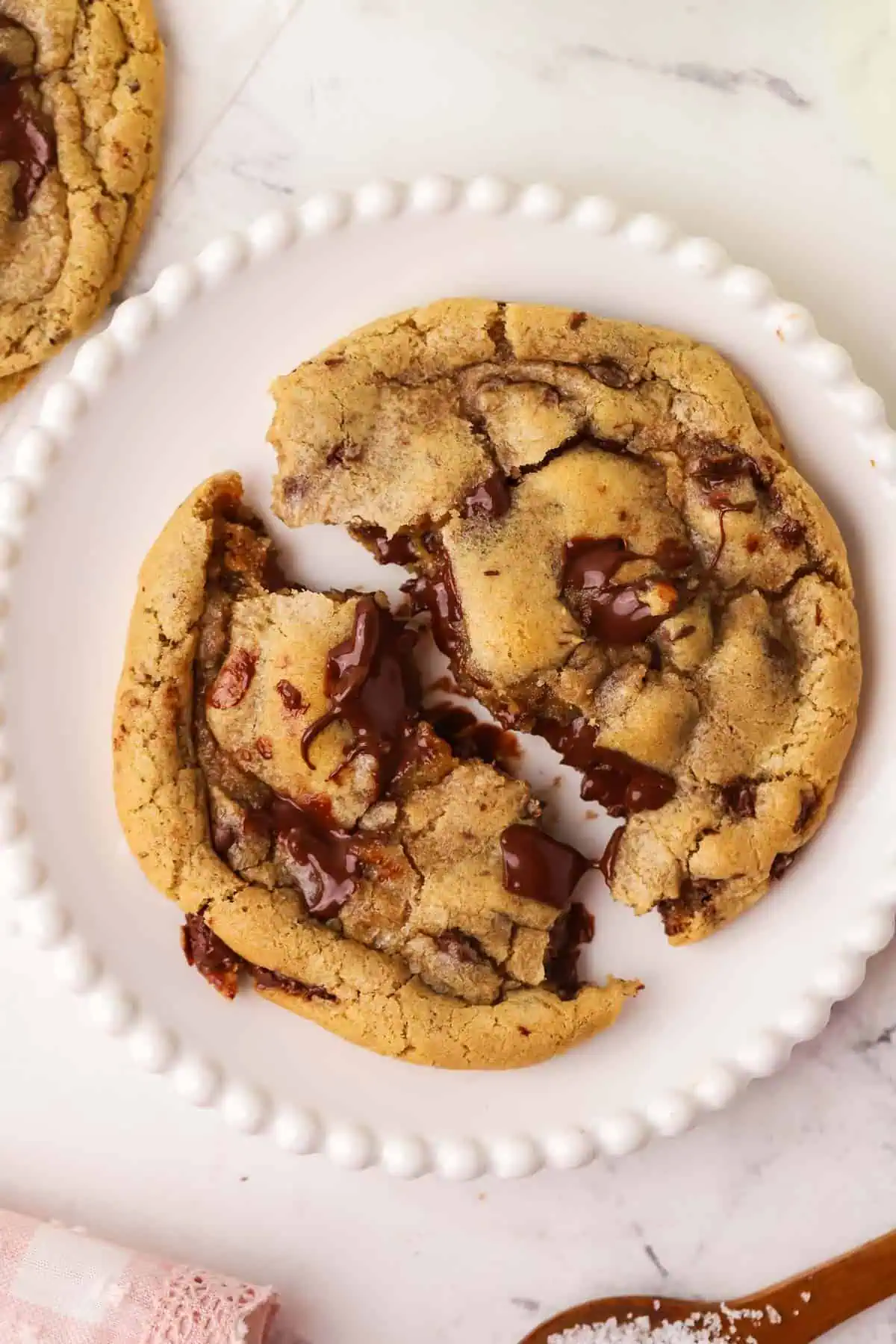 chocolate chip cookie on a plate pulled apart