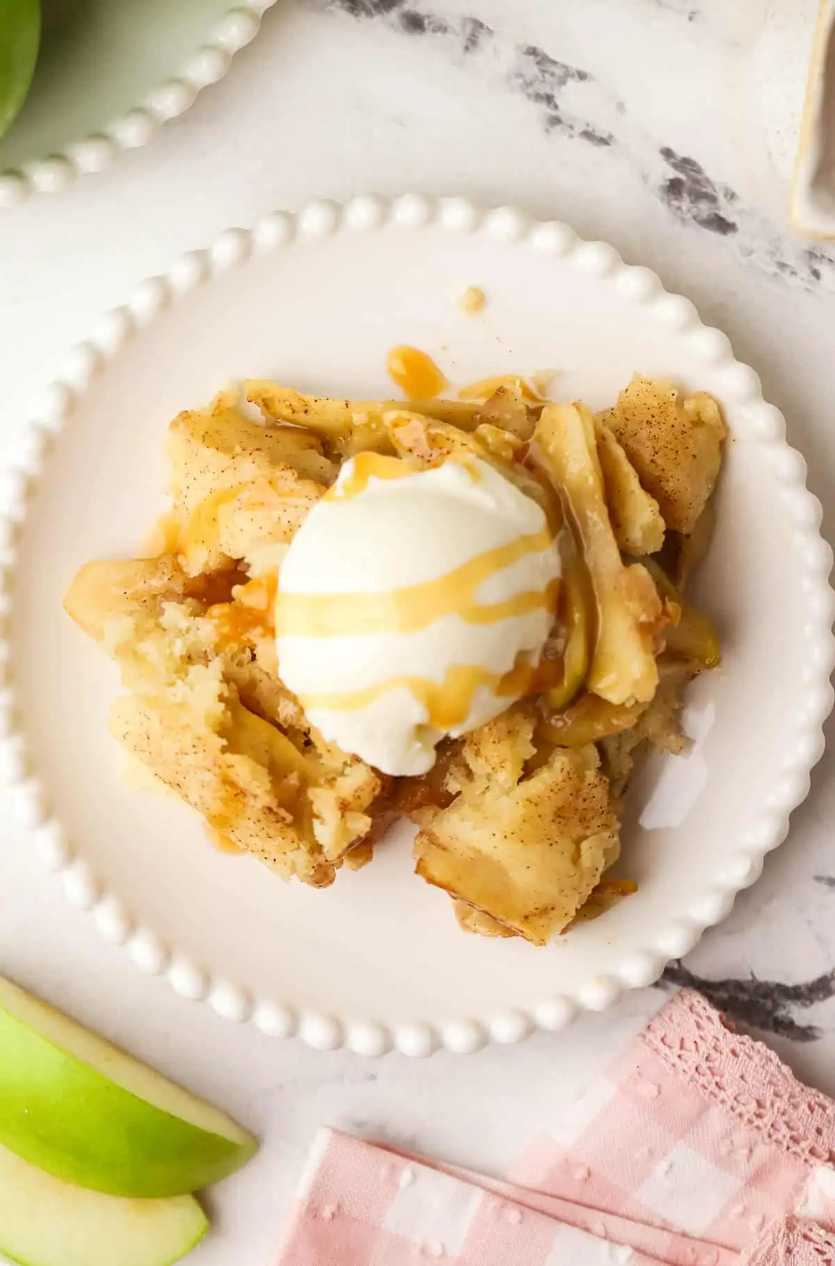 a serving of apple cobbler on a plate topped with ice cream
