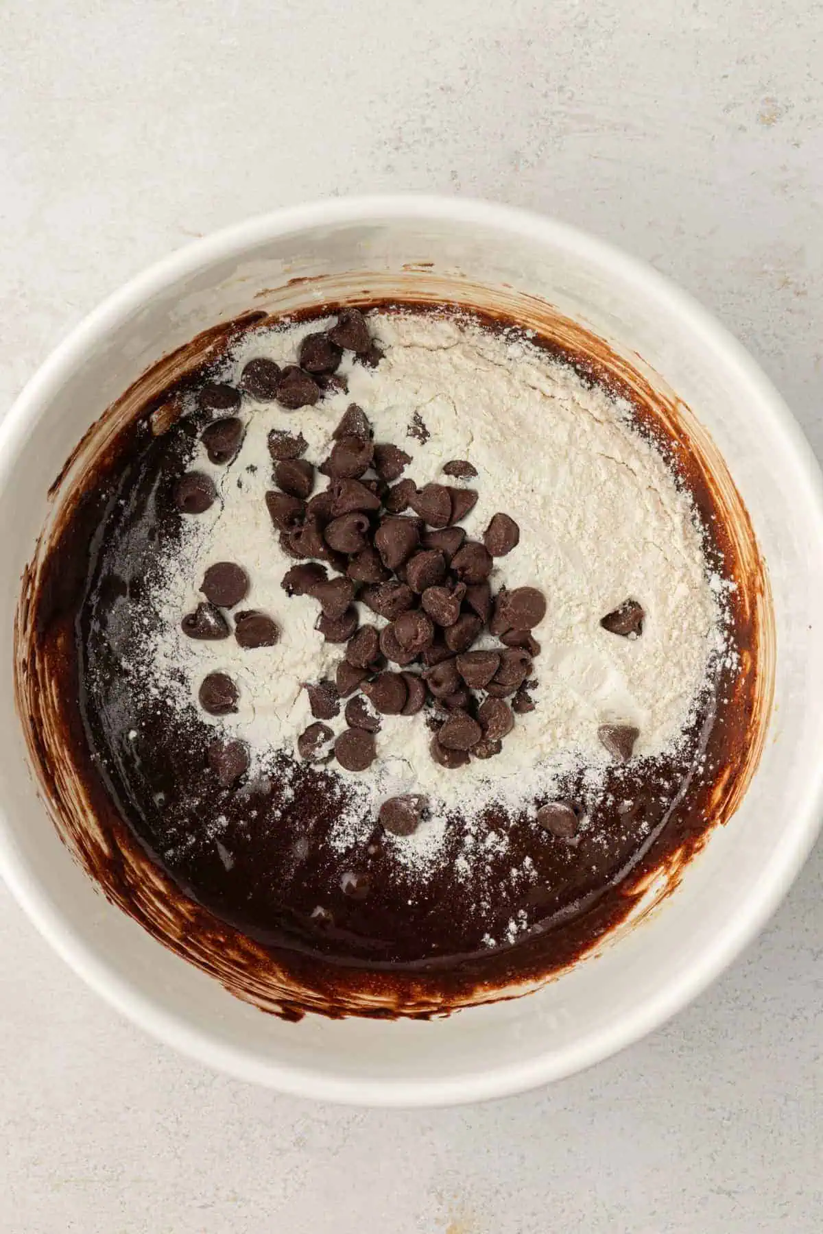 dry ingredients and chocolate chips added to brownie batter