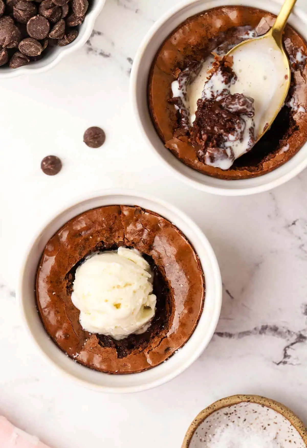 two brownie ramekins topped with ice cream