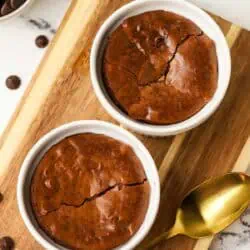 two brownie ramekins on a cutting board