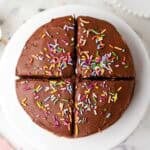 mini chocolate cake on a cake stand cut into four servings